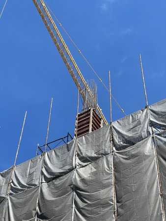 construction crane and building under blue sky