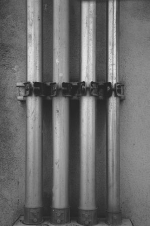 close up iron pipes on cement wallの写真素材