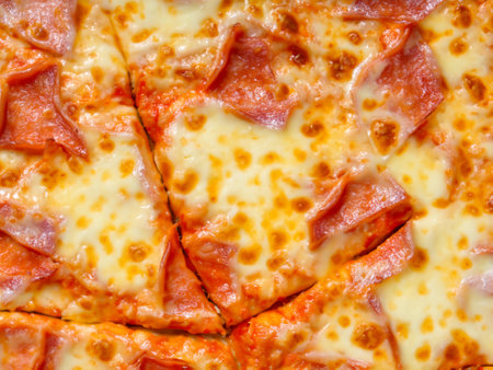 pizza slice with tomato, mozzarella cheese, basil and pepperoniの素材