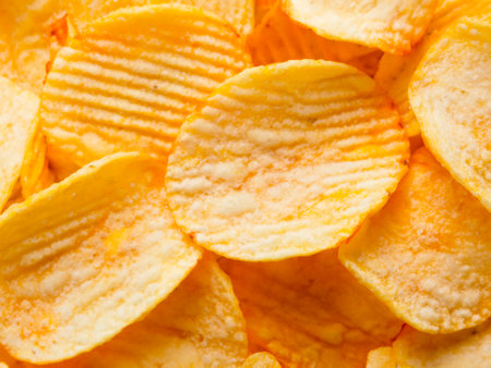 crispy potato chips in a bowl. top view.の素材