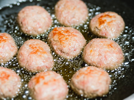 meatballs on a black pan with oil, close upの素材