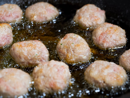 meatballs on a black pan with oil, close upの素材