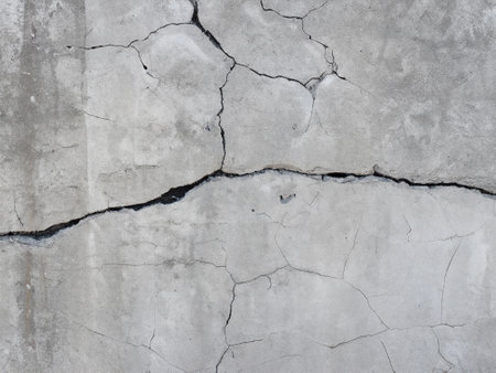 texture of old concrete wall with cracks and scratches which can be used as a backgroundの素材