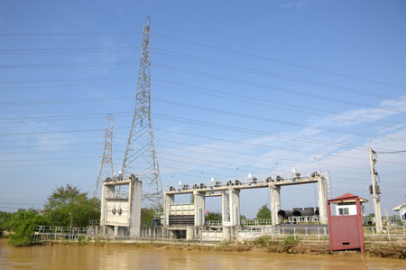 the electric cable station is on a background of green and blue sky. dam in country Thailand