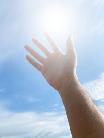 close up of man hand with blue skyの写真素材