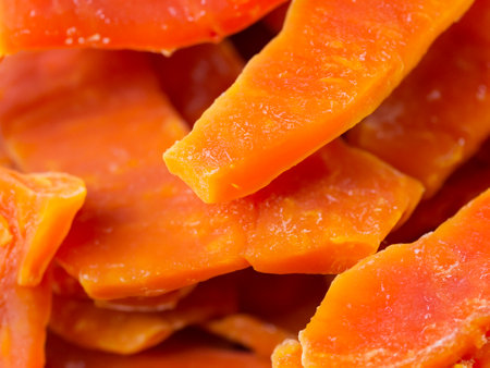 fresh papaya fruit slices as background, top viewの素材