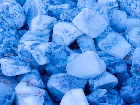 a pile of ice chunks sitting on top of a pile of rocksの素材