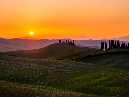 the beautiful sunrise over the tuscany landscape in italyの素材