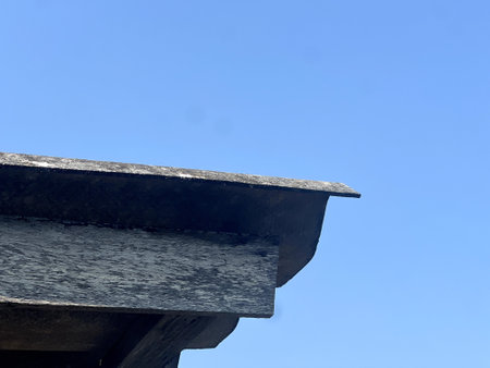 a closeup shot of a wooden roof on a blue sky background
