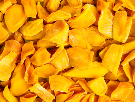 yellow mango fruit slices on white backgroundの写真素材