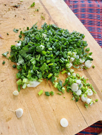 cooking chopped green onion on the wooden boardの写真素材