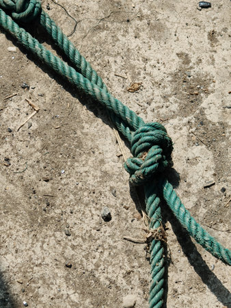 a closeup of a rope on a cement floor