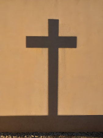 a cross on the wall of an old church on the backgroundの素材