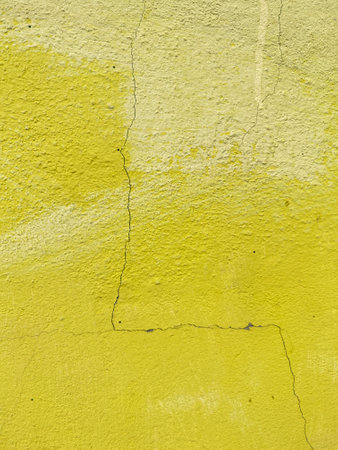 yellow cement wall texture backgroundの写真素材