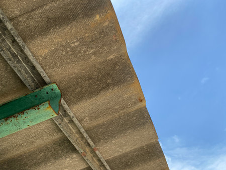 close up of old tile roof and sky.