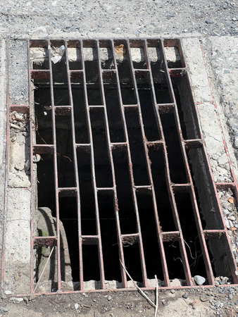 old dirty sewer cover on the street