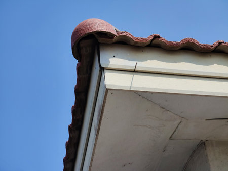 a closeup shot of a roof of an old building with a blue sky
