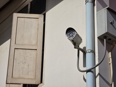 security camera on a wall in the street