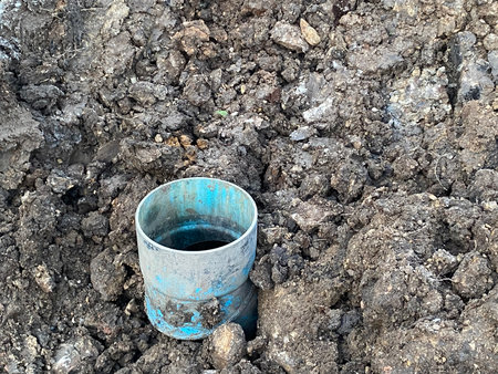 a closeup shot of pvc tube in the ground