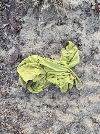 a yellow cloth is lying on the groundの写真素材