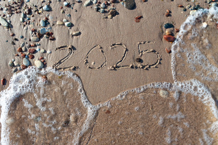 Message Year 2024 replaced by 2025 text written on beach sand background. Good bye 2024 hello to 2025 happy New Year coming concept. top view. Estoniaの写真素材