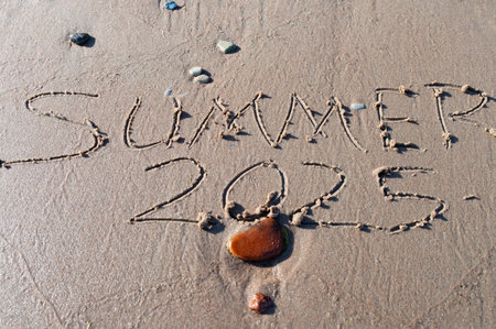 Summer 2025 text written on beach sand background. Good bye 2024 hello to 2025 happy New Year coming concept. top view.の写真素材
