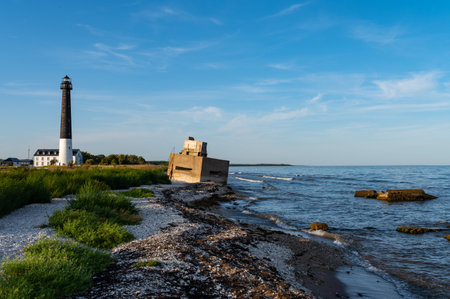 Sorve Lighthouse and border fortress. Located in Torgu Parish, Saaremaa over small bay. Summer day, bright blue sky over sand and gravel ground.の写真素材