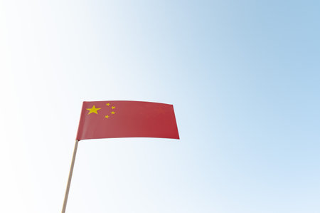 Close up of a flag of China on wooden pole. The national flag of the People's Republic of China. China economics, real estate, Pandemicの写真素材