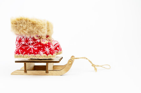 Concept Decoration. Red Nicholas Christmas on Sled boots isolated on white background. Winter boots,...