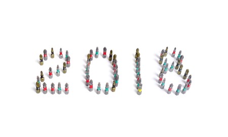 Set of heads for screwdriver (bits) in New year order 2018. Tools collection close up isolated on...