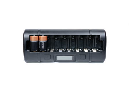 Quick and soft eigth cell AA, AAA, C, D black ultimate professional battery charger on white background.の写真素材
