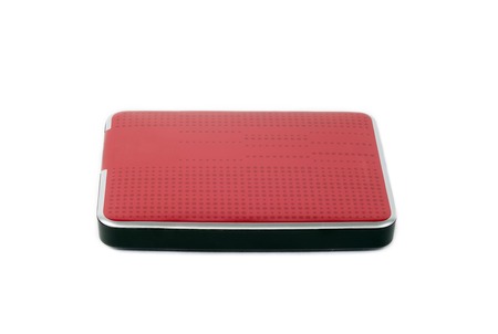 Red external hard drive for data storage and security. Portable disk hdd isolated on white background.の写真素材