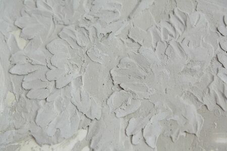 background and texture of a bas-relief pattern on a gray concrete wall