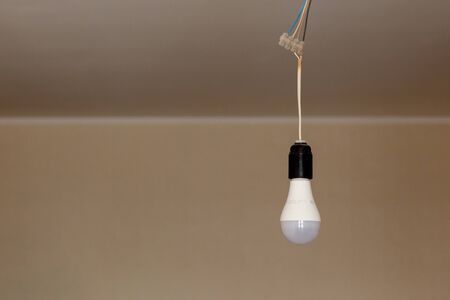electricity, LED energy-saving lamp hanging on the ceiling on the cable