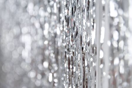 Christmas, New Year background and texture. Silver tinsel or shiny ribbonsの写真素材