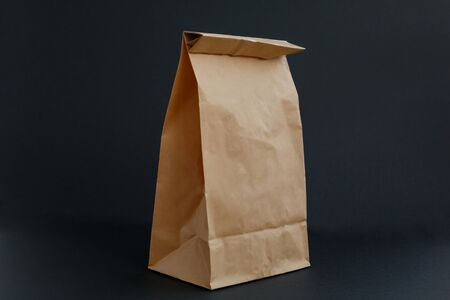 brown paper craft bag for shopping on a black backgroundの写真素材