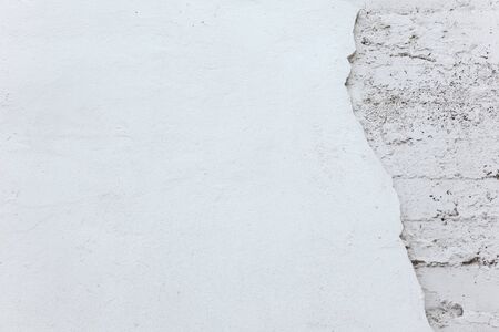 Texture and background. Destroyed white old concrete wall. Repair and constructionの写真素材