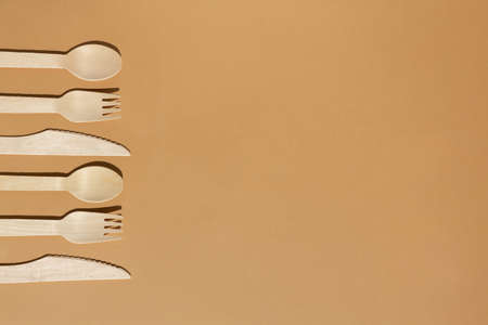 Contrast lighting. Eco friendly wooden cutlery. Fork, knife, spoon. Plastic Free Concept.