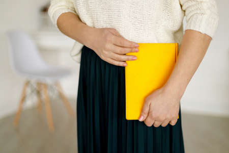 woman businessman holding a yellow notepad. Business planning and tasks for the day or week. Female in businessの写真素材