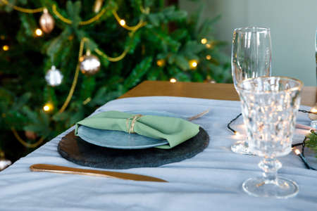 festive table setting, napkin on plate. New Year and Christmas holidays. Dishes in interiorの写真素材