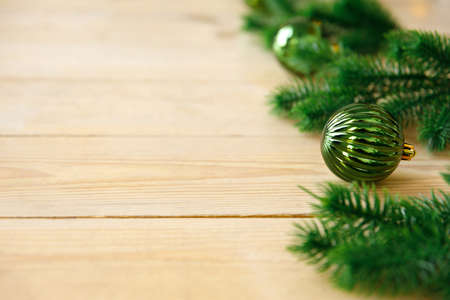 New Year and Christmas background. Artificial green spruce branches and Christmas tree toys balls on...