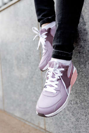 woman in pink sports shoes. Women's legs in sneakers close upの写真素材