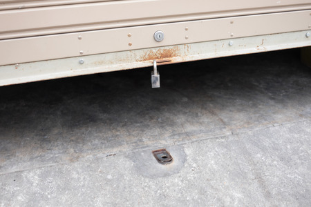 roll garage gate is opening up with the key hanging on itの写真素材