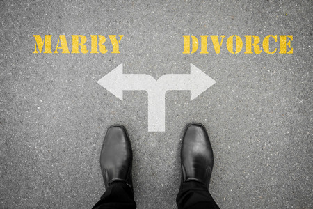 black shoes standing at the crossroad - marry or divorceの写真素材