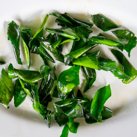 Fried kaffir lime leaves in white dishの写真素材