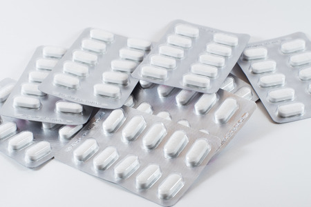 Isolated calcium carbonate tablet in aluminum foil packageの写真素材