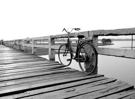 Black and white old bicycle on wooden bridgeの写真素材