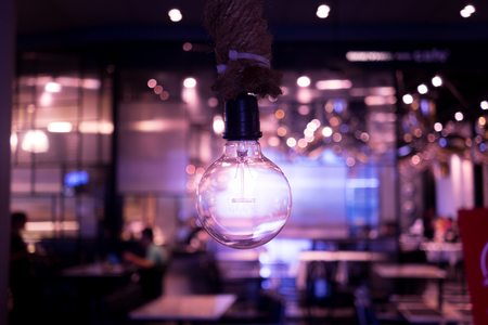 Hanging lamp and abstract blur restaurant in the background