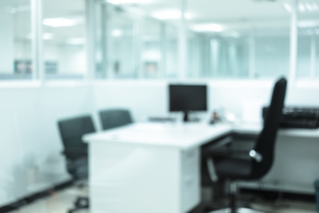 Abstract blur office interior. Desk, chair, computer, document, closet, partitionの写真素材