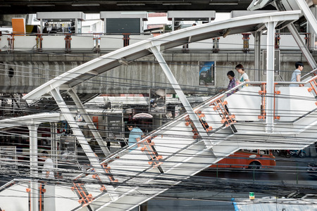 Bangkok, Thailand : January 31, 2016 : People walking down from Bangkok sky train station and messy electric wire along the streetのeditorial素材
